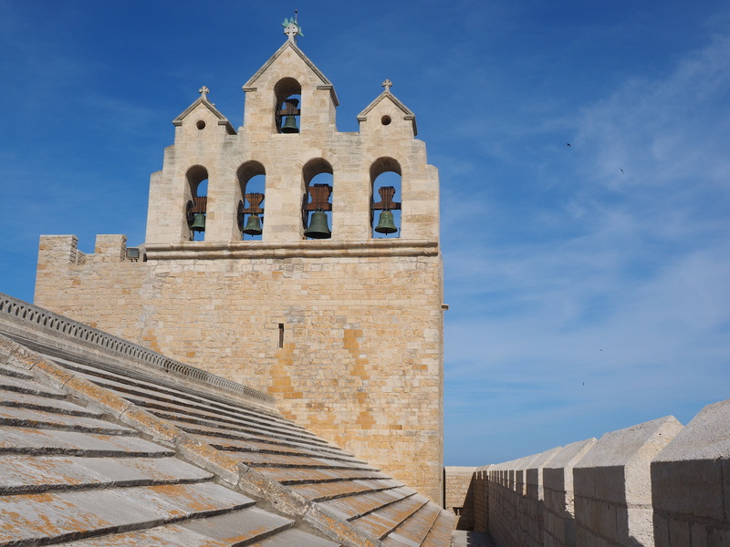 catholic, day, clock, notre-dame-de-la-mer, sky, sunlight, place of worship, no people, saintes-maries-de-la-mer, monument, low angle view, blue, bouches-du-rhône
