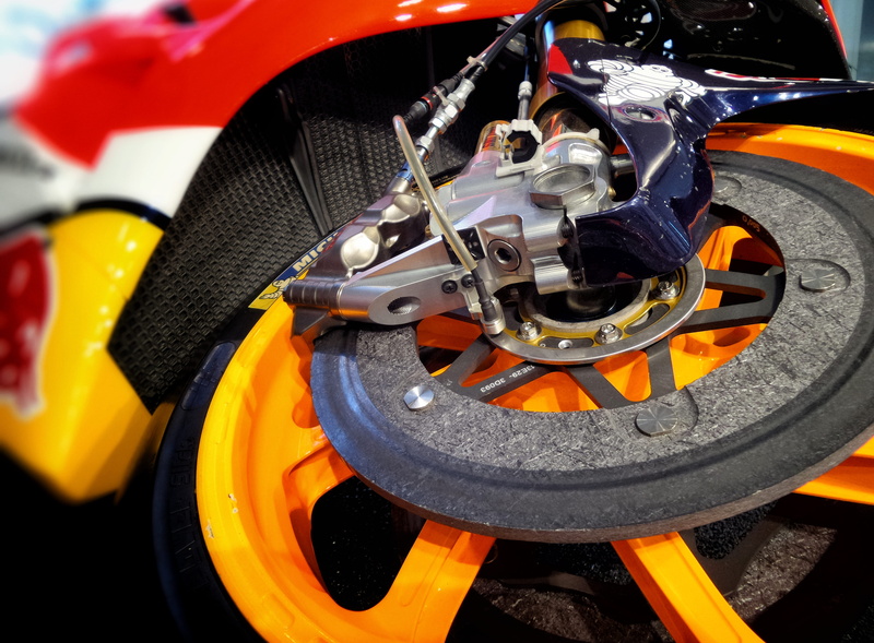 technology, mode of transportation, race, stationary, show, motor vehicle, outdoors, orange, showroom, day, no people, brake, land vehicle, yellow, white