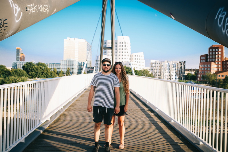 valentine, sunny, two people, serious, couple - relationship, looking at camera, young women, architecture, young men, emotion, symmetry, front view, city