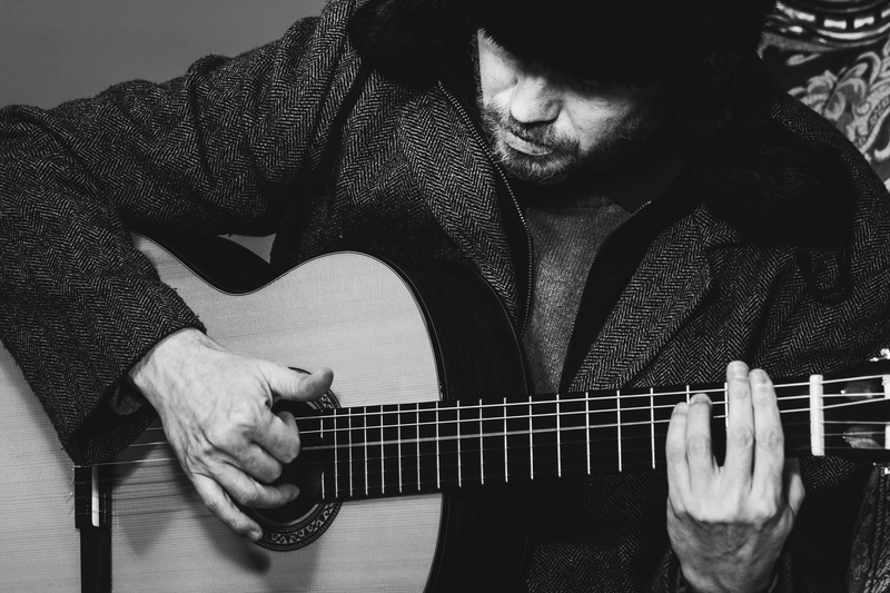 guitar, arts culture and entertainment, musical instrument, holding, coat, russian hat, urss, lifestyles, leisure activity, one person, front view, real people