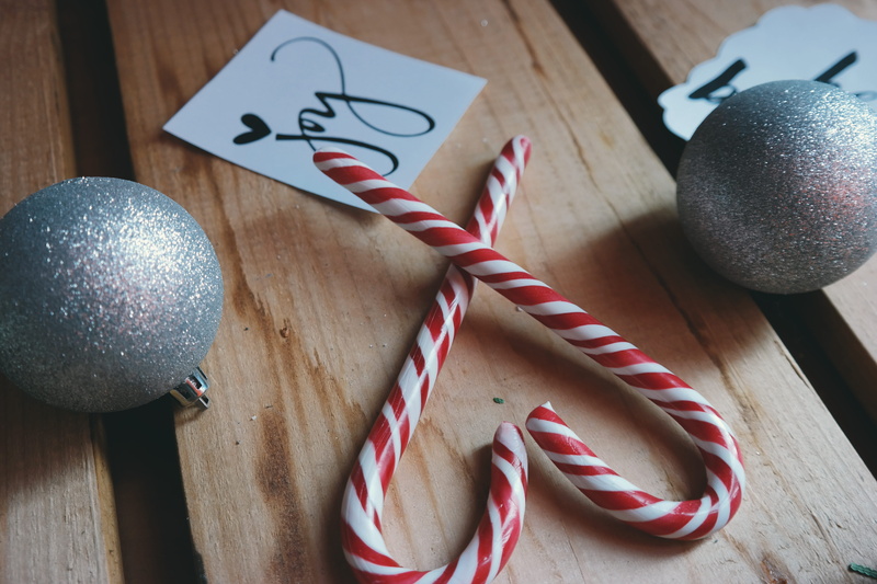 table, close, wood, candy cane, high angle view, decoration, text, close-up, food and drink, stripe, art and craft, christmas balls, shining, still life