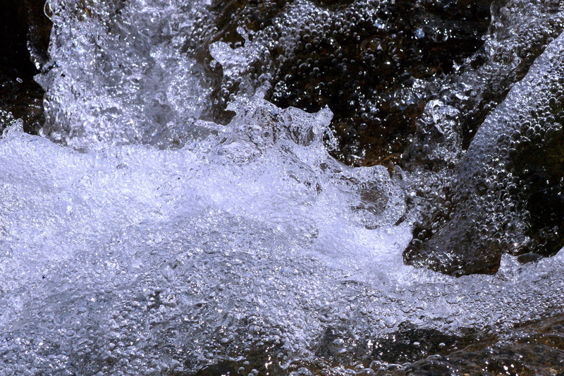splash, bubbly, sparkling, water running, solid, outdoors, land, rock - object, waterfall, beauty in nature, freshness, drip, idyllic, motion, rock, sport