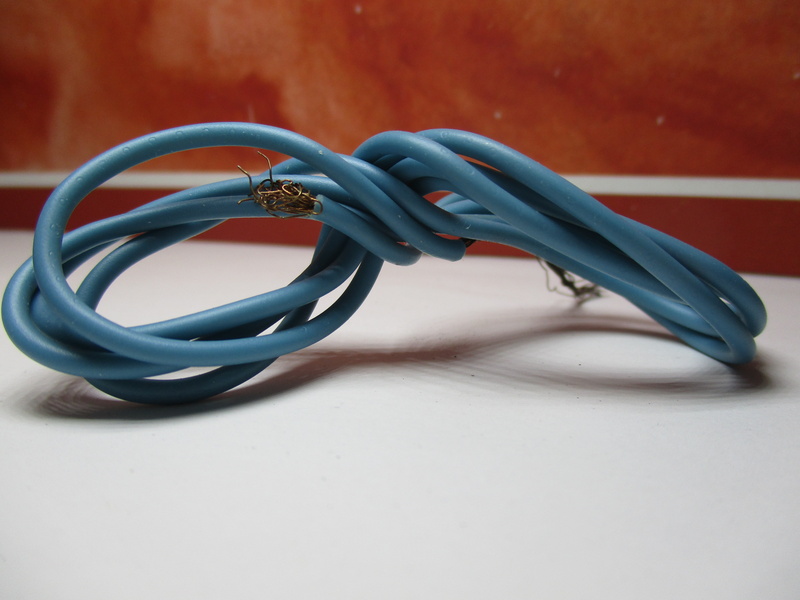 intertwined, electrical equipment, computer cable, electric wire, electric current, tied knot, still life, cable, studio shot, tied up, table, tangled