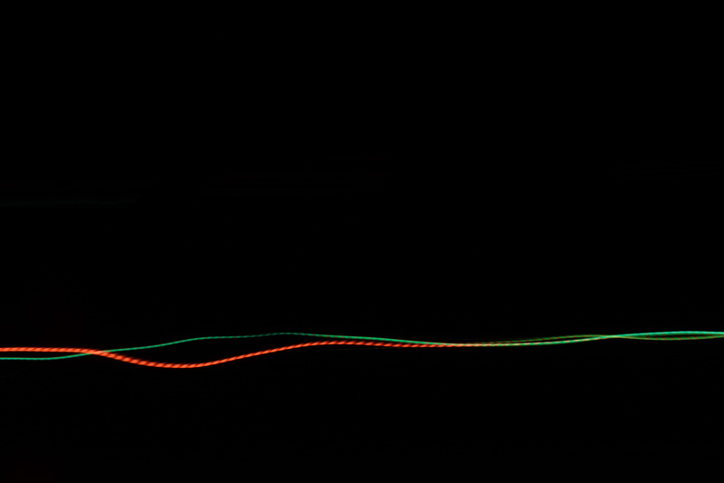 lines, red, black background, multi colored, power supply, intertwined, green color, single line, long exposure, copy space, electricity, 5K, indoors