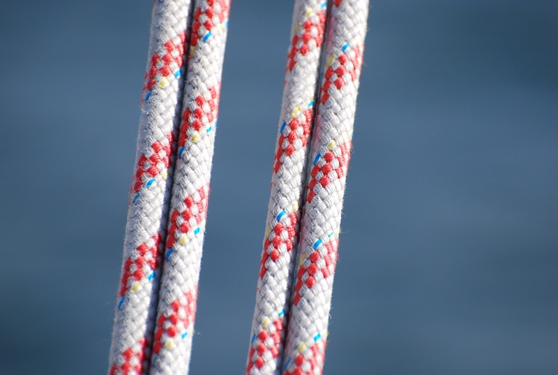studio shot, sailing, copy space, 2K, red, striped, intertwined, no people, lake, outdoors, boat, nature, hanging, sky, close-up, blue, connection, textile