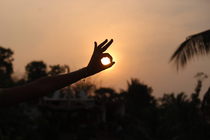 orange color, sunrise, body part, real people, sun, lifestyles, sky, hand gesture, hand raised, outdoors, hand, finger, beauty in nature, human finger