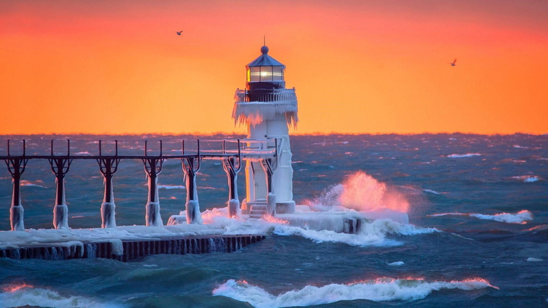 lighthouse, ice, evening, power in nature, sunset, sea, orange color, pier, coast, built structure, aquatic sport, beauty in nature, tower, sky, water