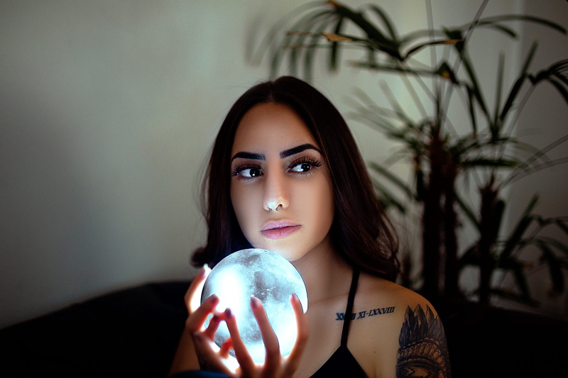 hairstyle, woman, adult, women, nose ring, one person, sphere, fortune teller, holding, long hair, beauty, facial expression, beautiful, lighted, illuminated