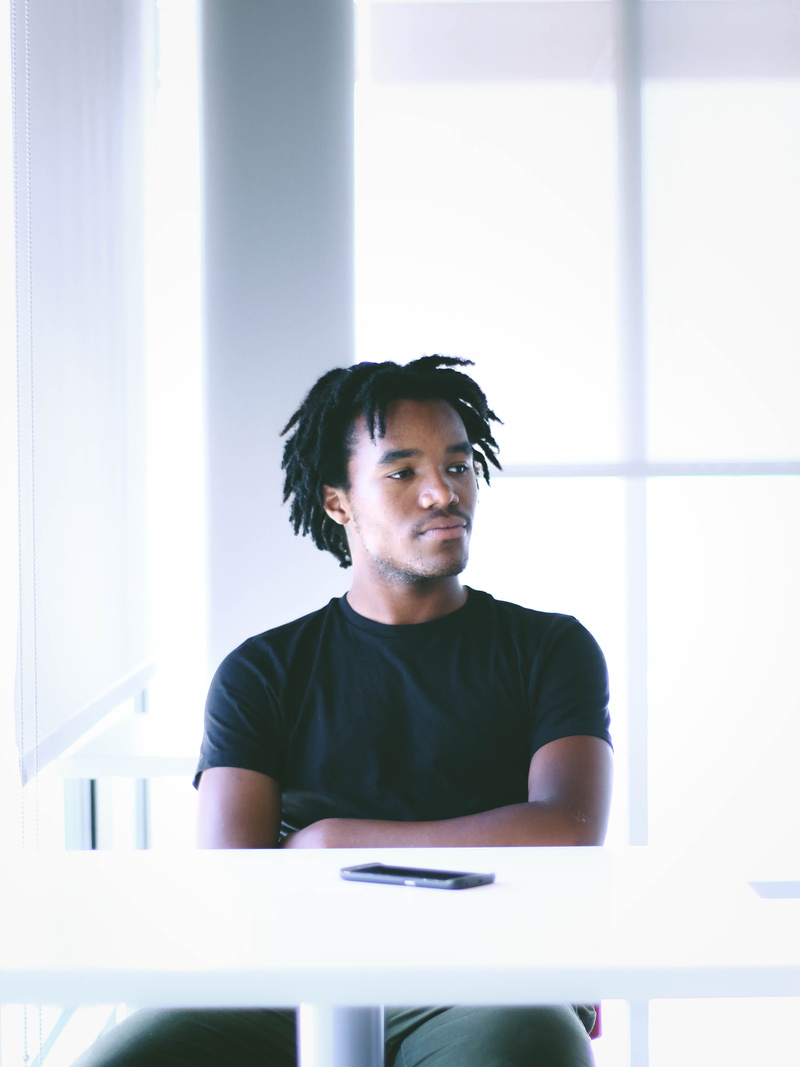 men, near, male, phone, model, casual clothing, front view, furniture, front, young adult, waist up, white, indoors, real people, portrait, desk, seating