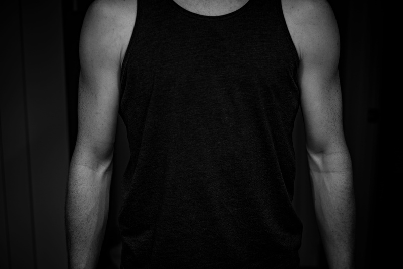adult, black background, midsection, human body part, model, black and white, tshirt, lifestyles, skin, waist up, casual clothing, grayscale, tank, shirt