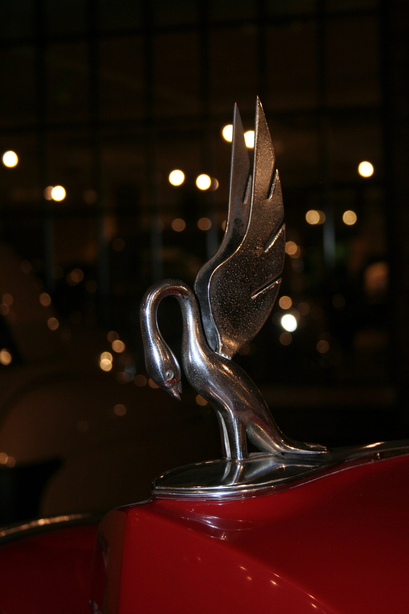 shape, focus on foreground, antique, swan, no people, indoors, ornament, Ornament, burning, shiny, close-up, Front, fire, motor vehicle, mode of transportation
