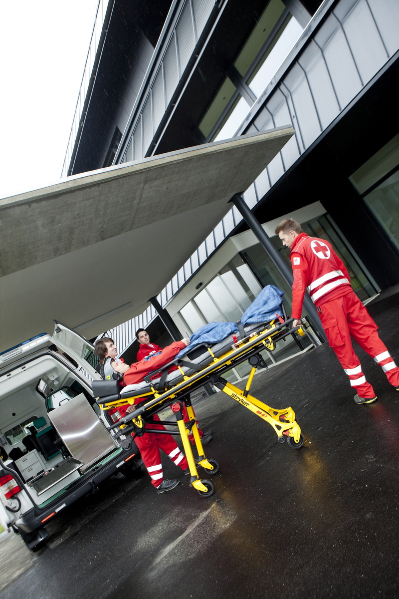 incidental people, mode of transportation, clinic, building exterior, car, occupation, trauma surgery, transportation, working, outdoors, clothing, people