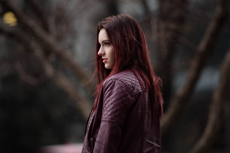 depth of field, hair, looking into the distance, outdoors, profile, 4K, young adult, waist up, leather jackets, young women, red jackets, portrait, standing