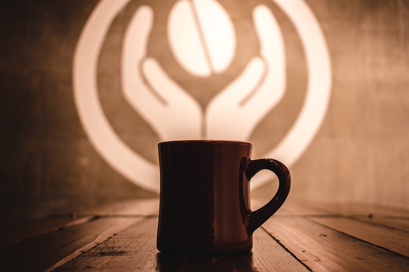 illuminated, coffee - Drink, heat - Temperature, crockery, indoors, latte, cafe, refreshment, table, steam, brown, mug, hot drink, focus on foreground