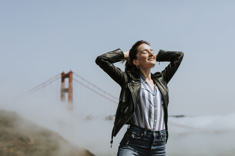 leather jacket, front view, basking, leisure activity, arms raised, leather, dom, young adult, 4K, lifestyles, enjoyment, women, sky, standing, looking away