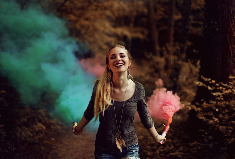 leisure activity, young adult, looking at camera, three quarter length, lifestyles, emotion, blue smoke, focus on foreground, casual clothing, beautiful woman