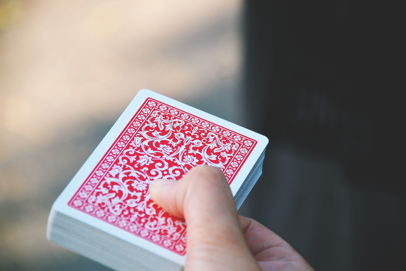close-up, selective focus, container, anticipation, red, one person, leisure games, arts culture and entertainment, holding, cards, single object, various