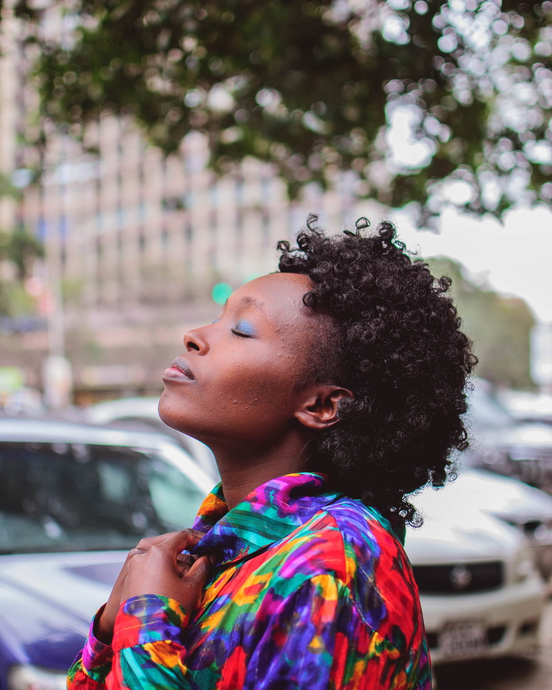 young adult, child, profile view, portrait, curly hair, vehicles, woman, wearing, hairstyle, person, real people, focus on foreground, shirt, outdoors