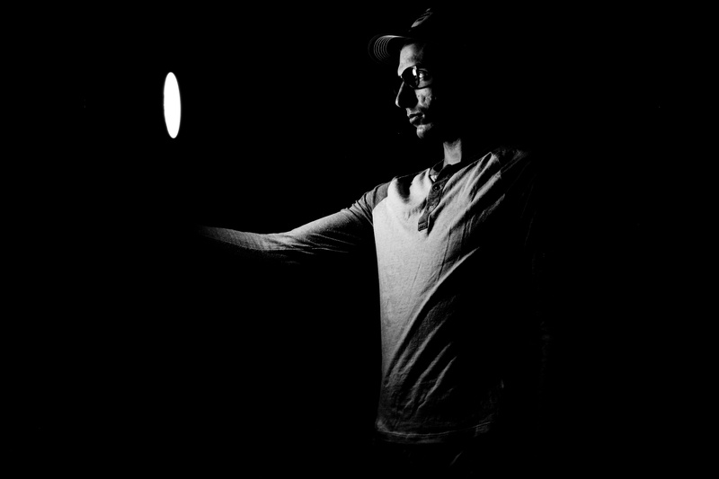 black And White, adult, standing, low Key, light, inside, holding, fashion, front view, clothing, room, leisure activity, lifestyles, looking, dark, studio shot
