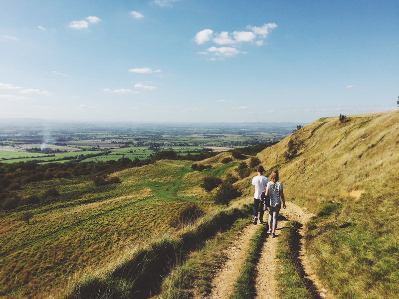 fields, outdoors, woman, landscape, tranquil scene, hiking, blue, trekking, beauty in nature, adults only, day, hills, time, people, non-urban scene, real people