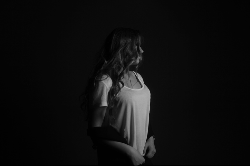 young women, depression - sadness, standing, casual clothing, black and white, adult, looking, black background, women, hairstyle, hair, tshirt, lifestyles
