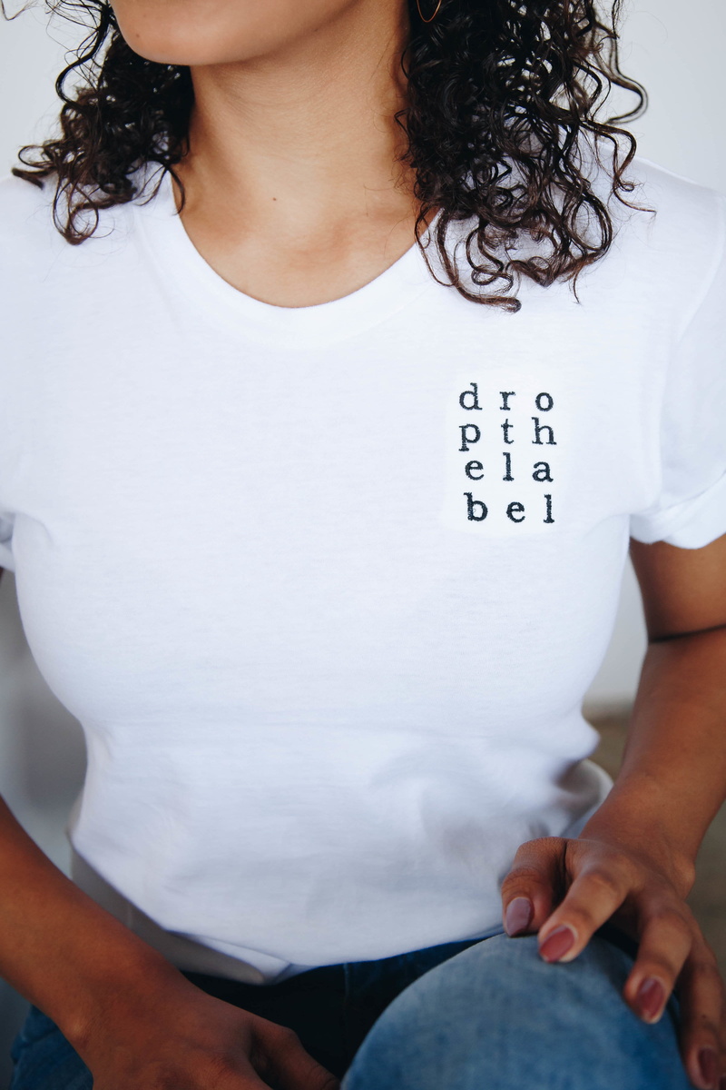 tshirt, midsection, sitting, real people, lifestyles, wearing, adult, message, standing, hairstyle, casual clothing, holding, young adult, text, women