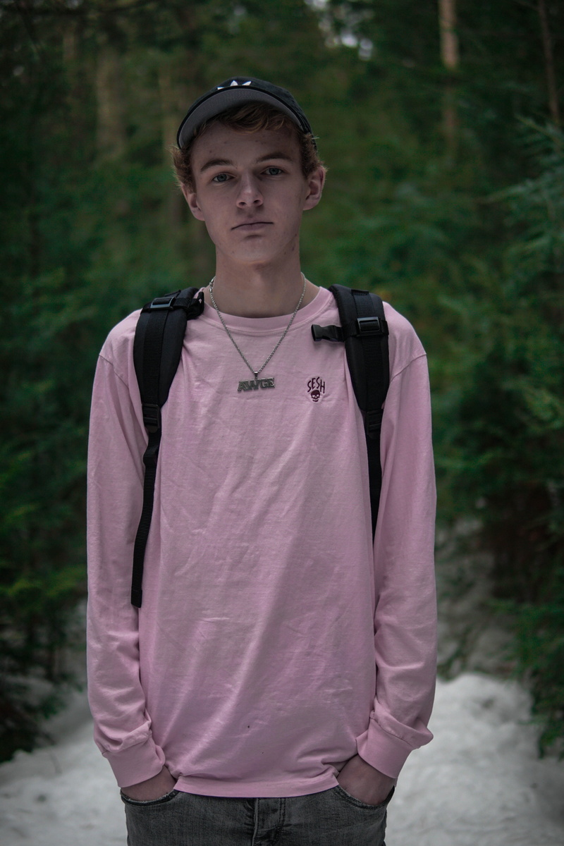 necklace, person, day, clothing, hood, man, wearing, jay, long sleeve, leisure activity, young adult, apparel, lifestyles, confidence, animal, handsome