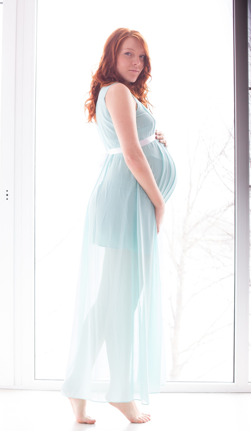 dress, beautiful woman, pregnancy, indoors, fashion, window, caucasian Ethnicity, stand by, in anticipation of the, adult, sunlight, redhead, family, long hair