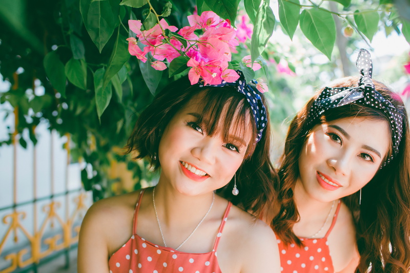 flowering plant, real people, asian, looking at camera, girls, portrait, headshot, smiling, female, twins, beautiful woman, flower, child, outdoors, happiness