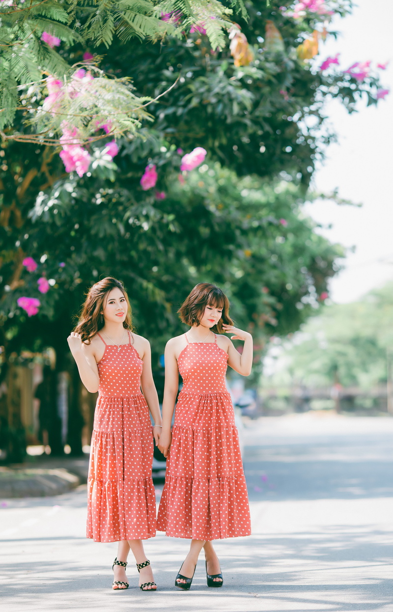 wearing, day, adult, lady, 5K, brunette, females, female, polka, trees, sister, near, polka dot, two, teenager, dresses, woman, dress, petaled, standing