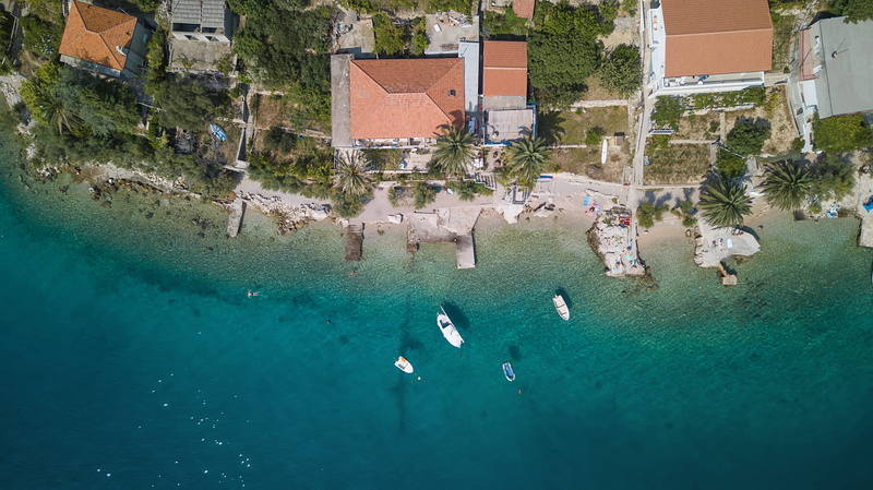 water, swimming pool, outdoors, shore, no people, animal, boats, large group of animals, waterfront, bird, aerial, nature, beach, croatia, makarska, sea