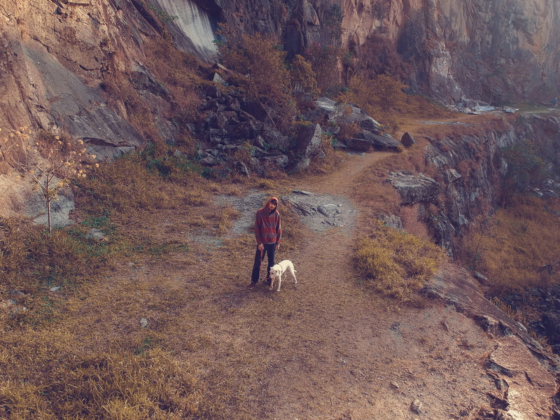 dog, mountain, casual clothing, real people, valley, hiking, path, person, walking, non-urban scene, cliff, canyon, landslide, full length, mining, day