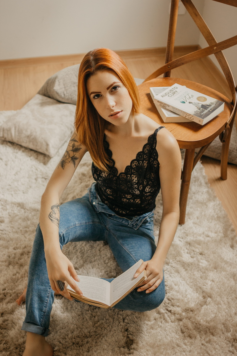 tattooed woman, lifestyles, furniture, wooden, room, three quarter length, lacey top, leisure activity, young women, brown, beauty, rug, studying, looking up
