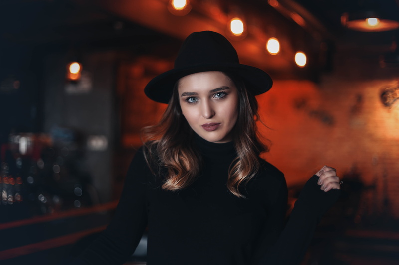 fitted, cowboy hat, bar, face, sleeve, female, young women, standing, glass, portrait, bar counter, beauty, inside, long sleeve, waist up, coat, sun hat