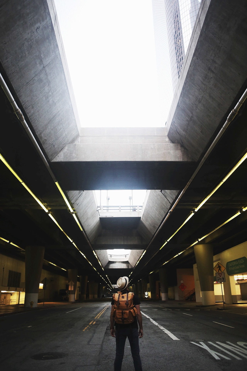 building, the way forward, rucksack, day, daytime, underground, leather, brown, architecture, full length, direction, t-shirt, gray, adult, pants, urban