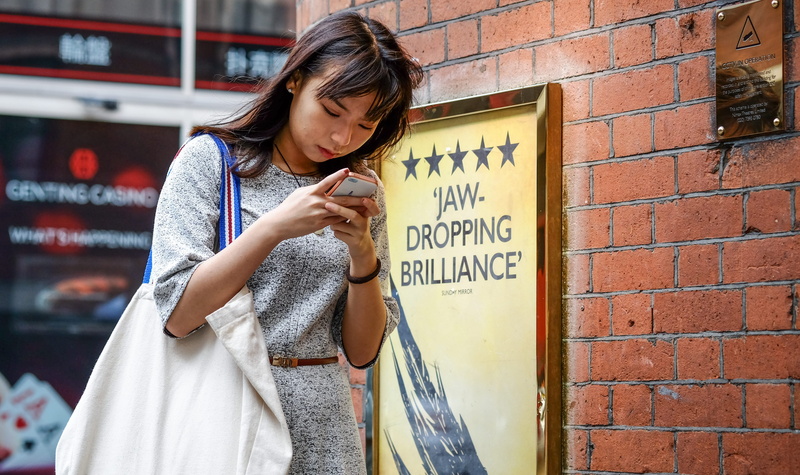 standing, adult, clothing, women, united kingdom, holding, human, mobile phone, soho, wall, girl, brick, hairstyle, smart phone, 4K, dropping, text, architecture