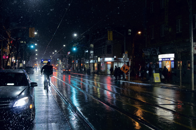 wet, man, building exterior, human, motor vehicle, flare, rain, outdoors, riding, people, night, tarmac, vehicle, person, group of people, 5K, city life
