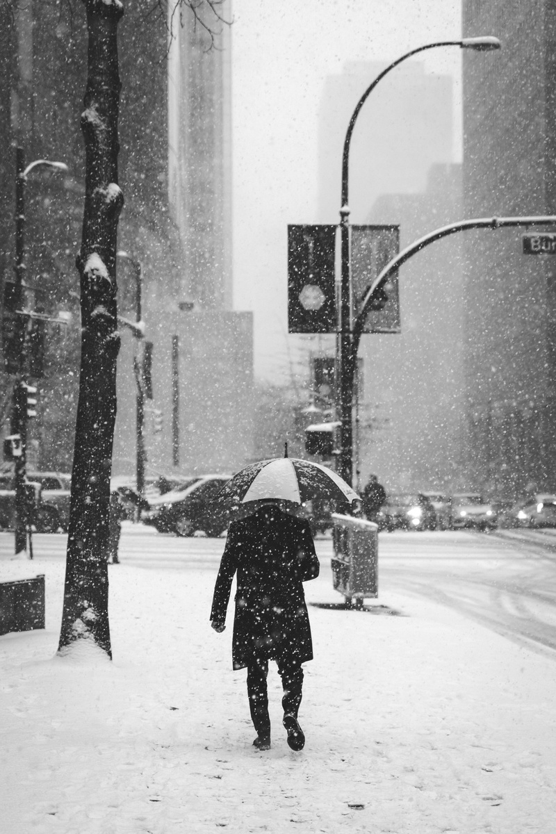 building exterior, storm, person, near, snowing, snow, blizzard, light, urban, architecture, outdoors, holding, real people, 5K, full length, black, umbrella