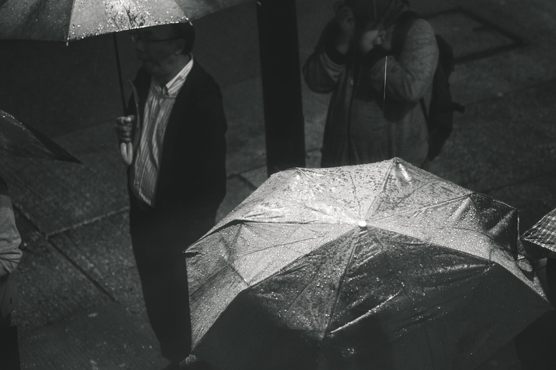 black and white, wear, high angle view, umbrella, man, safety, city, outdoors, leaf, photo, 4K, holding, protection, men, low section, portrait, street