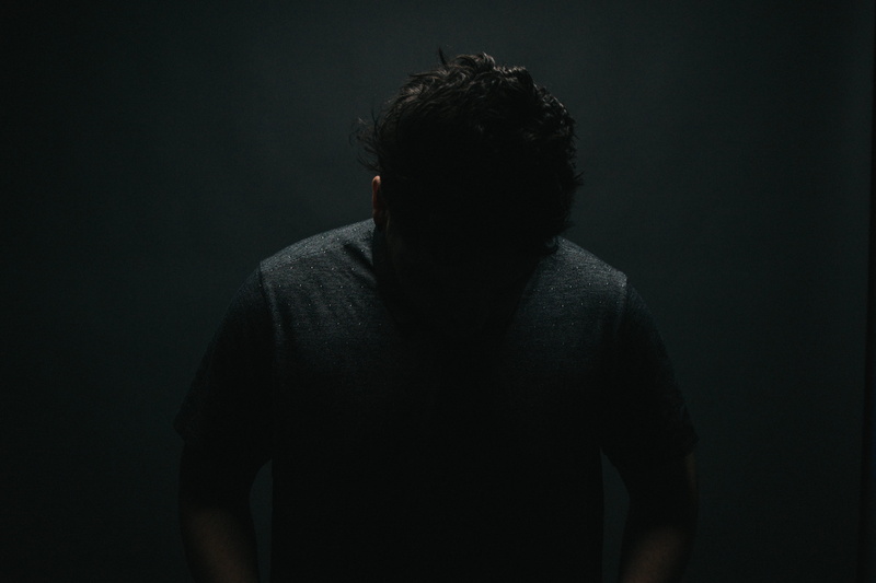 black, dark, sadness, neck, solitude, boy, adult, hairstyle, black background, standing, shirt, one person, ear, indoors, gray, crew, person, 5K, hide