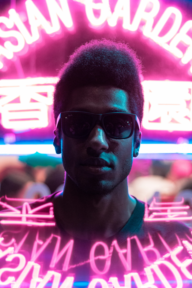 fashion, african american, text, signage, close-up, 5K, one person, reflection, western script, crew, city, lifestyles, neon, top, real people, focus on foreground