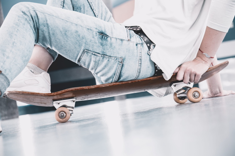 denim wear, day, person, seating on skate, one person, skateboard, faceless, sports equipment, midsection, human body part, low section, jeans, skateboarder