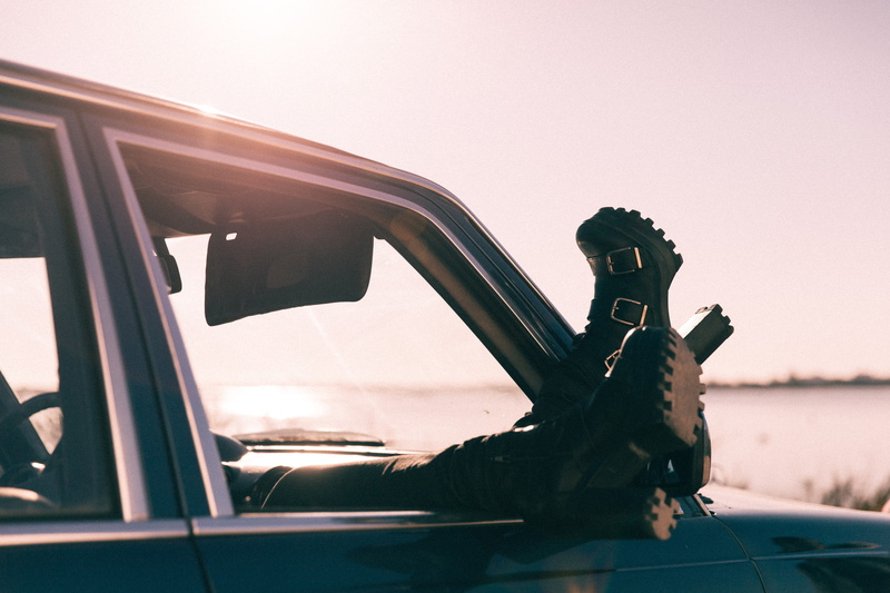 motor vehicle, outdoors, transportation, nature, animal, glass - material, sitting, one man only, clear sky, car, wearing, black, day, driving, travel