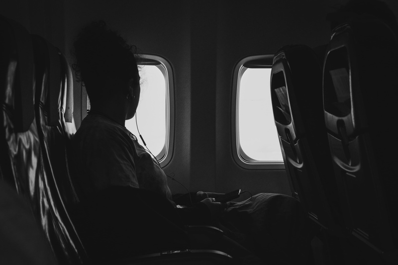 real people, automobile, mode of transportation, travel, lifestyles, airplane, one person, seat, land vehicle, 5K, grayscale, vehicle seat, flying, aerial