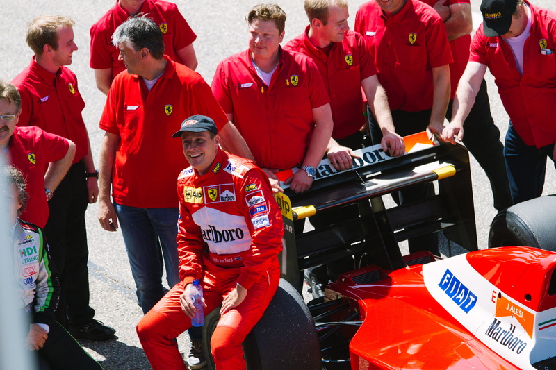 group, adult, day, marlboro, group of people, sponsor, men, black, red, mid adult men, mid adult, sitting, sport, young adult, man, car, daytime, people