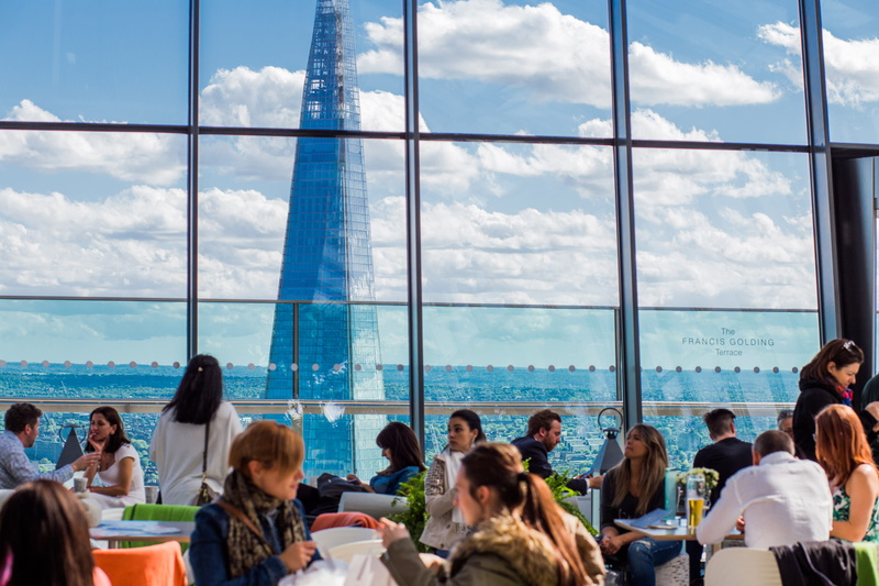 building, lunch, leisure activity, crowd, real people, steel, windows, large group of people, people, women, window, outdoors, cloud - sky, eating, skyscraper