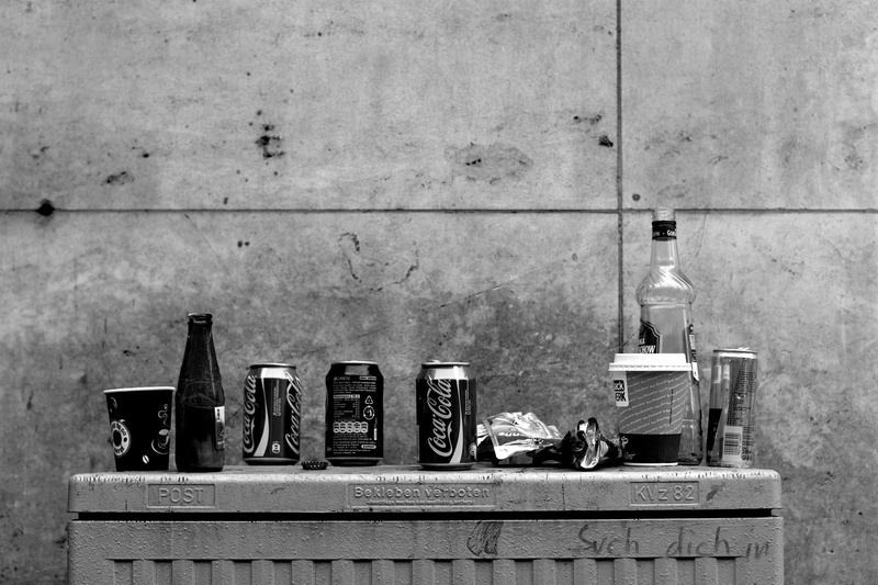 garbage, day, box, alcohol, wall - building feature, side by side, built structure, wall, table, bottle, grayscale, side of the road, photo, box - container