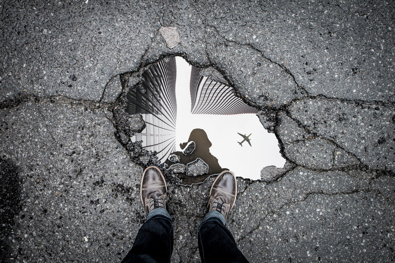 jeans, directly above, human body part, puddle, real people, outdoors, water, person, low section, front, body, street, cracks, personal perspective, lifestyles