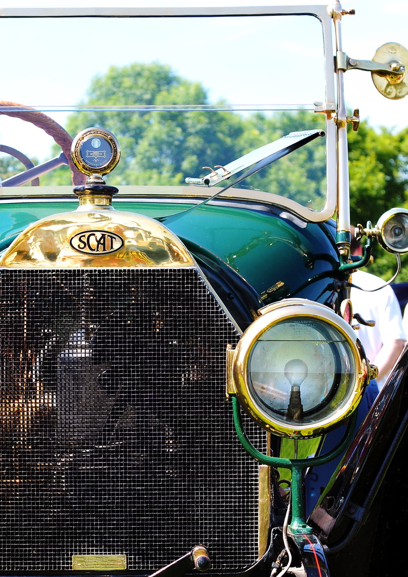 nature, focus on foreground, no people, land vehicle, text, brass, automotive, vehicle, classic car, vintage car, outdoors, 2K, close, motor vehicle, emblem