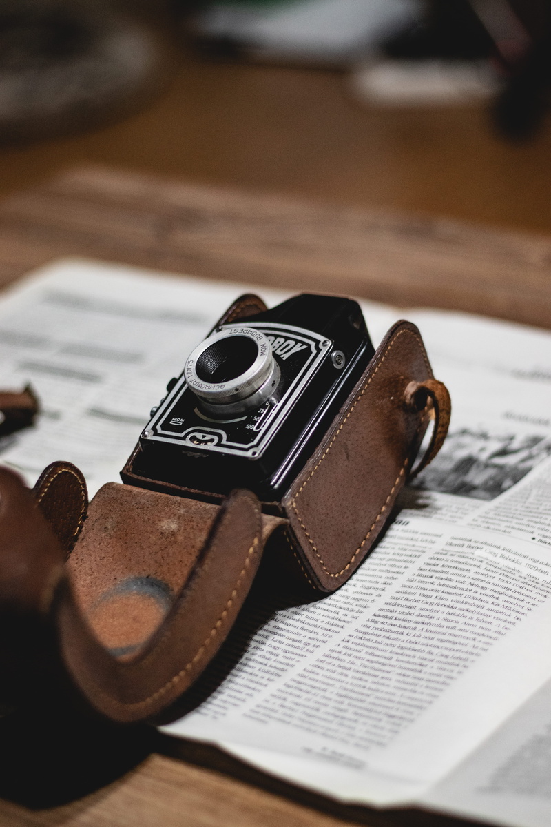 wristwatch, table, communication, banister, leather, metal, crime, electronics, no people, brown, indoors, bookcase, camera lens, skin, close-up, case